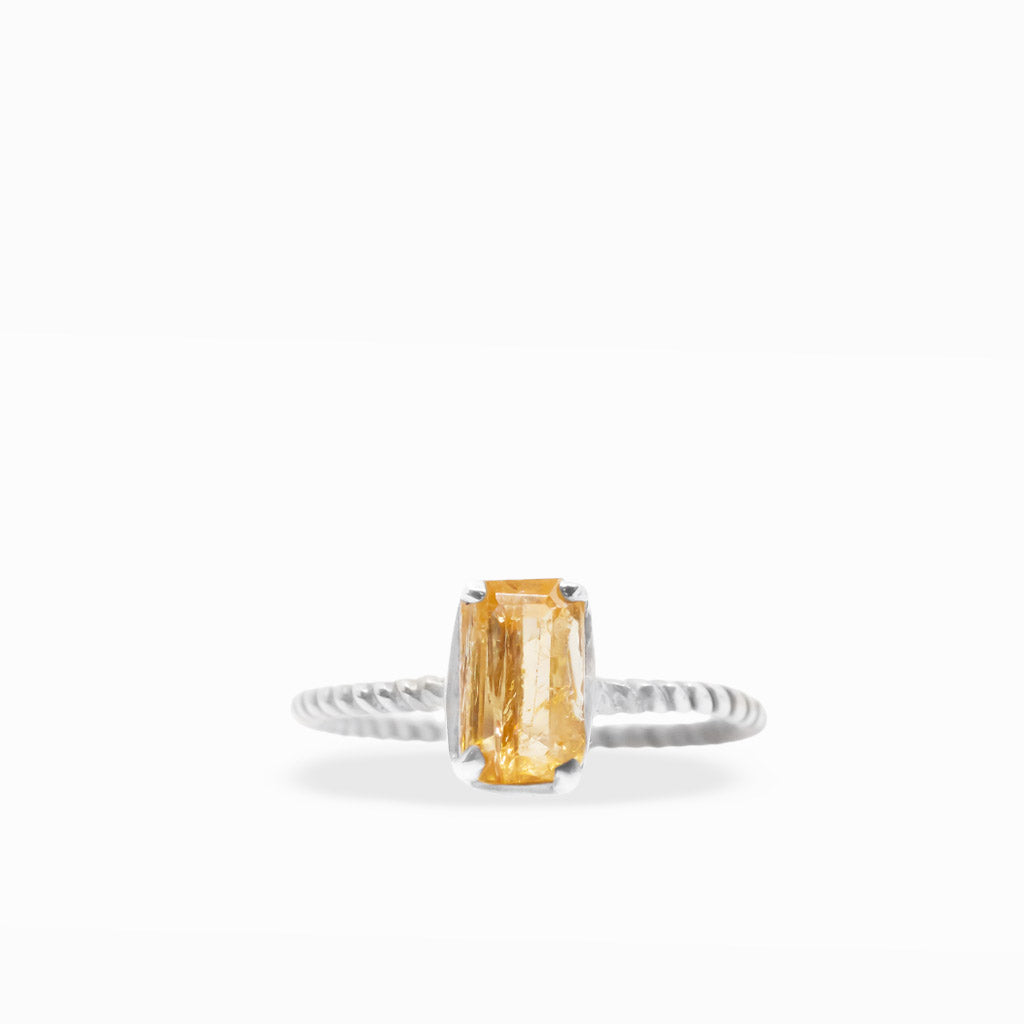 Golden-orange emerald-cut Imperial Topaz ring with sterling silver prong setting and delicate twisted rope-style band.