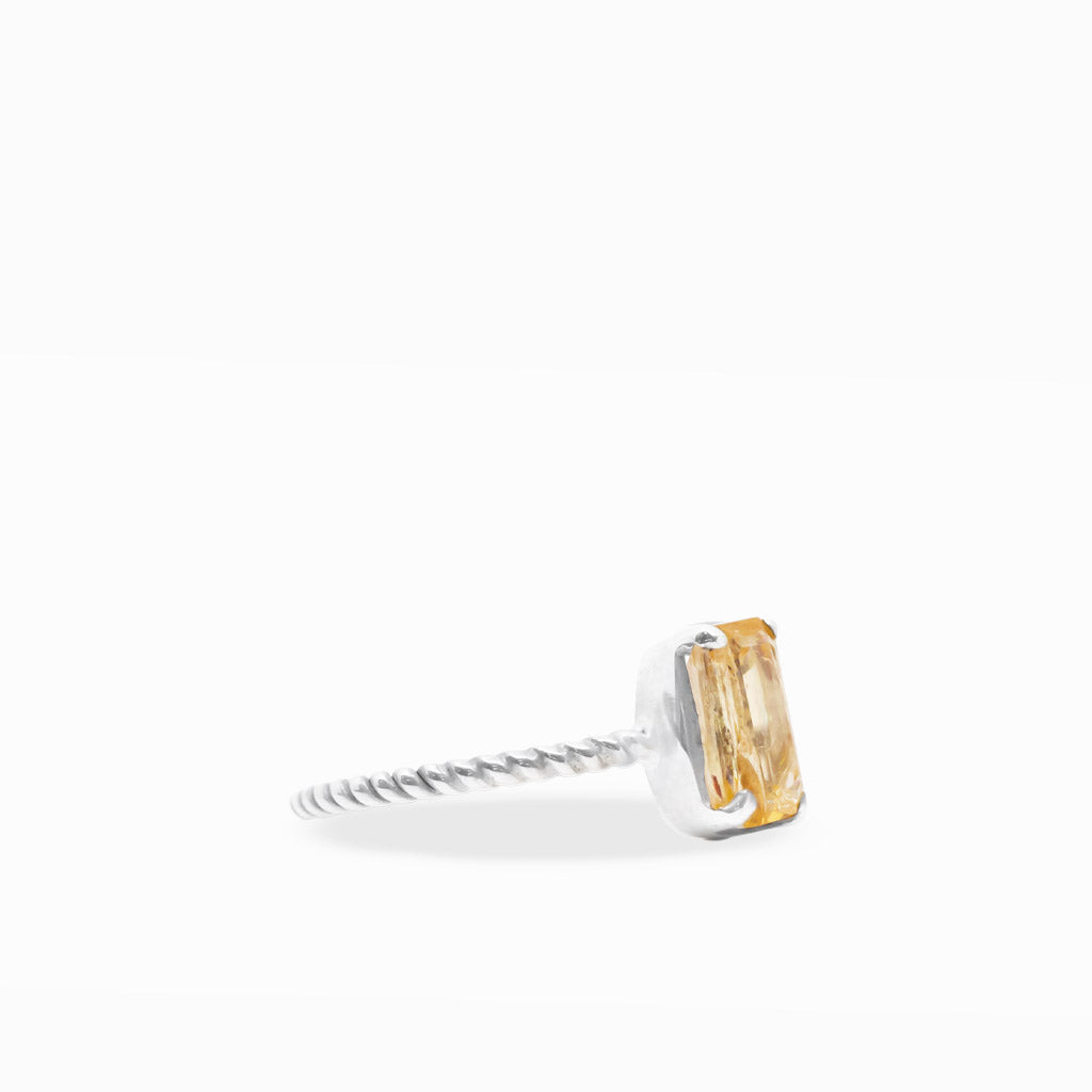 Golden-orange emerald-cut Imperial Topaz ring with sterling silver prong setting and delicate twisted rope-style band.