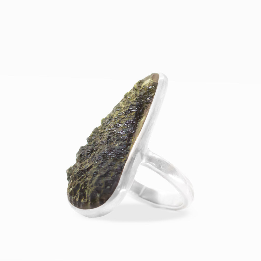 Freeform olive-green Moldavite ring with translucent textured tektite surface, polished sterling silver bezel setting, and smooth band.
