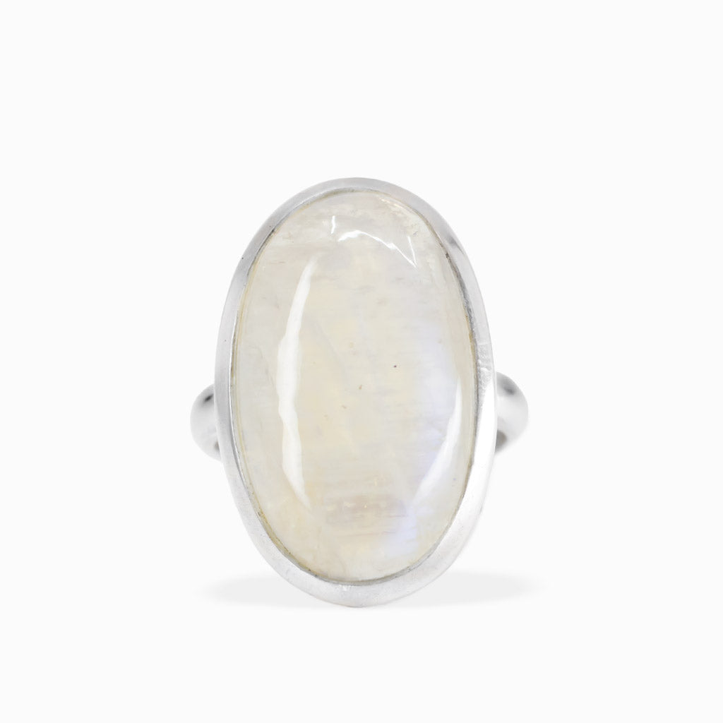Large oval Rainbow Moonstone ring with milky-white cabochon, subtle iridescent sheen, and polished sterling silver bezel setting.