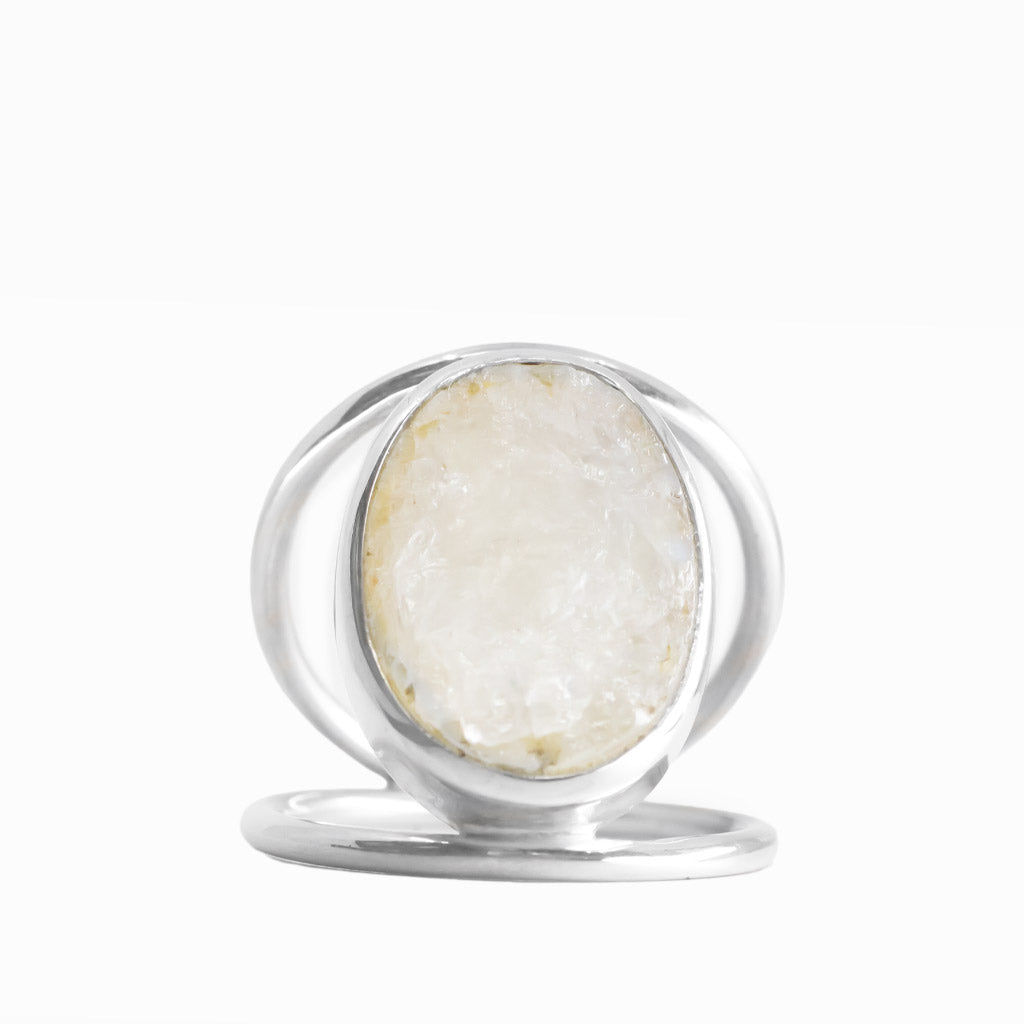 Oval Rainbow Moonstone ring with milky-white gemstone, subtle natural inclusions, polished sterling silver bezel, and openwork band.