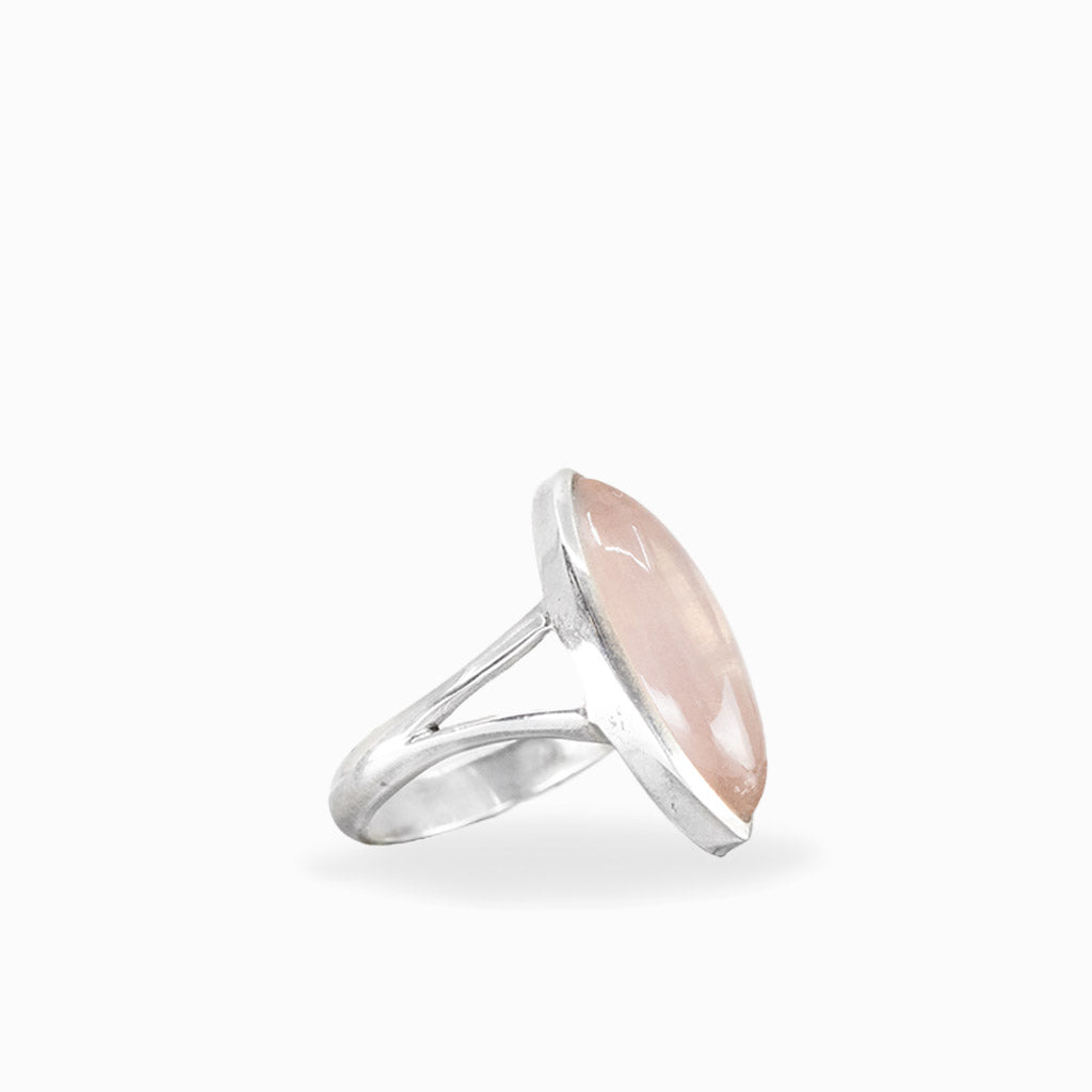 Marquise Rose Quartz ring with soft blush-pink cabochon, polished sterling silver bezel setting, and elegant split band.