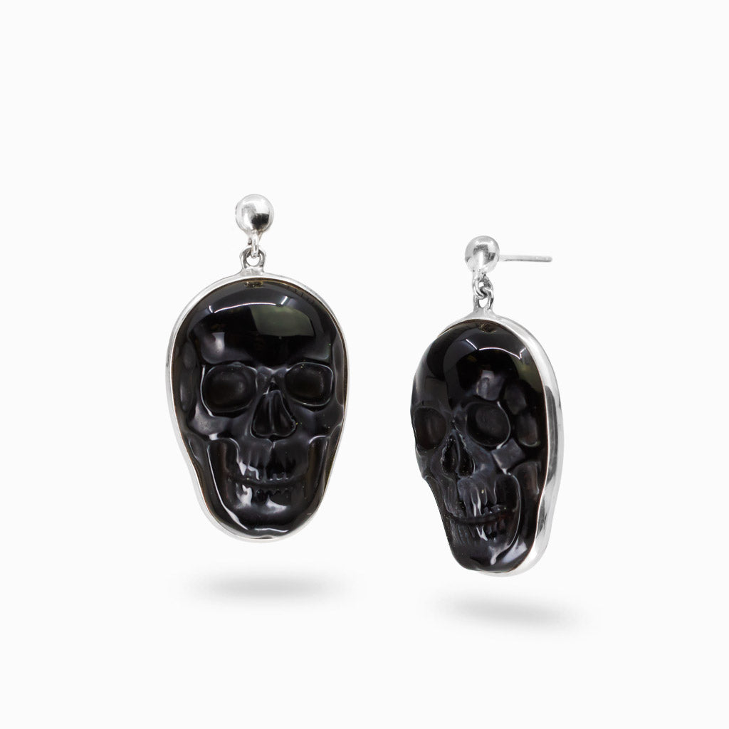 Sterling silver stud drop earrings featuring hand-carved black Obsidian skull gemstones.