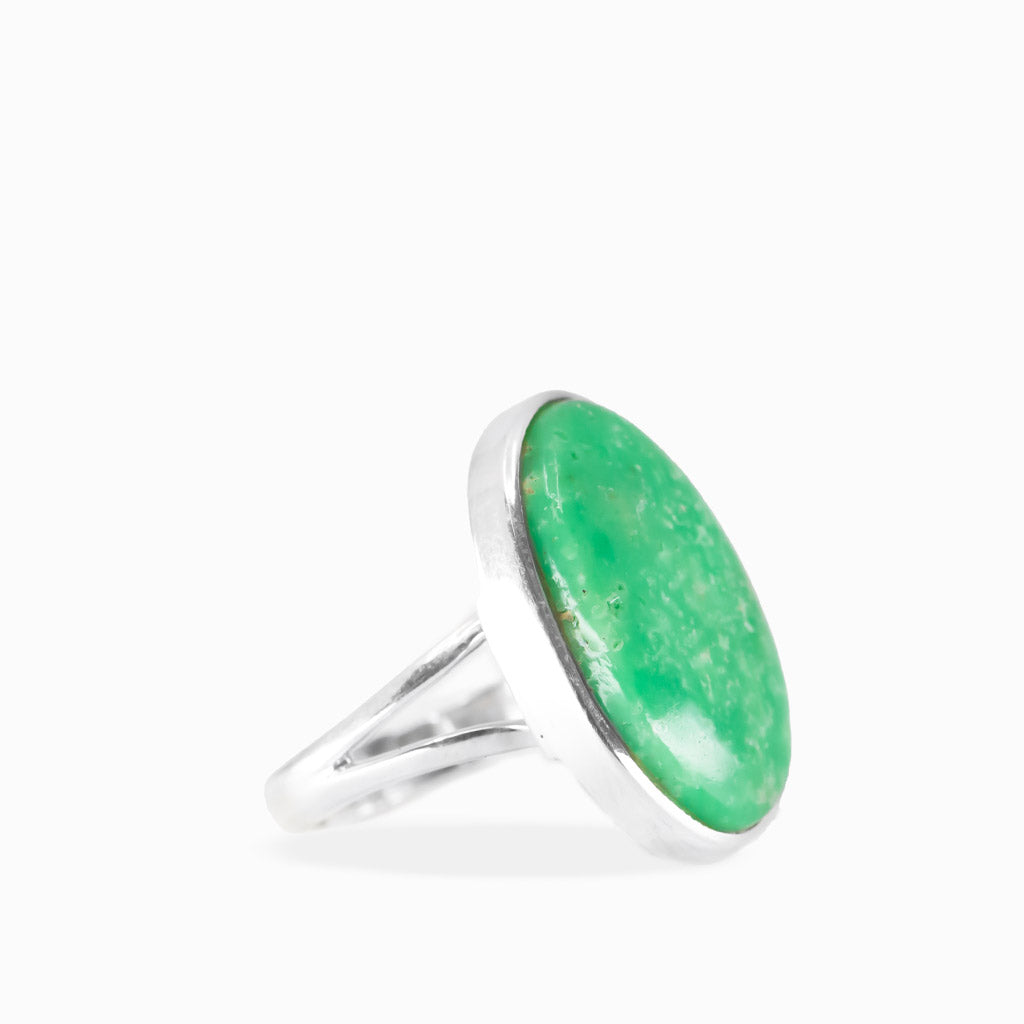 Oval Variscite ring with vivid emerald-green cabochon, subtle natural mottling, and polished sterling silver bezel setting.