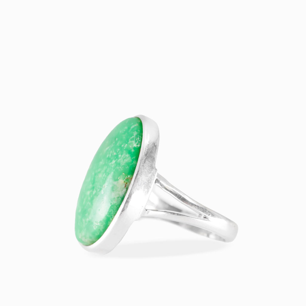 Oval Variscite ring with vivid emerald-green cabochon, subtle natural mottling, and polished sterling silver bezel setting.