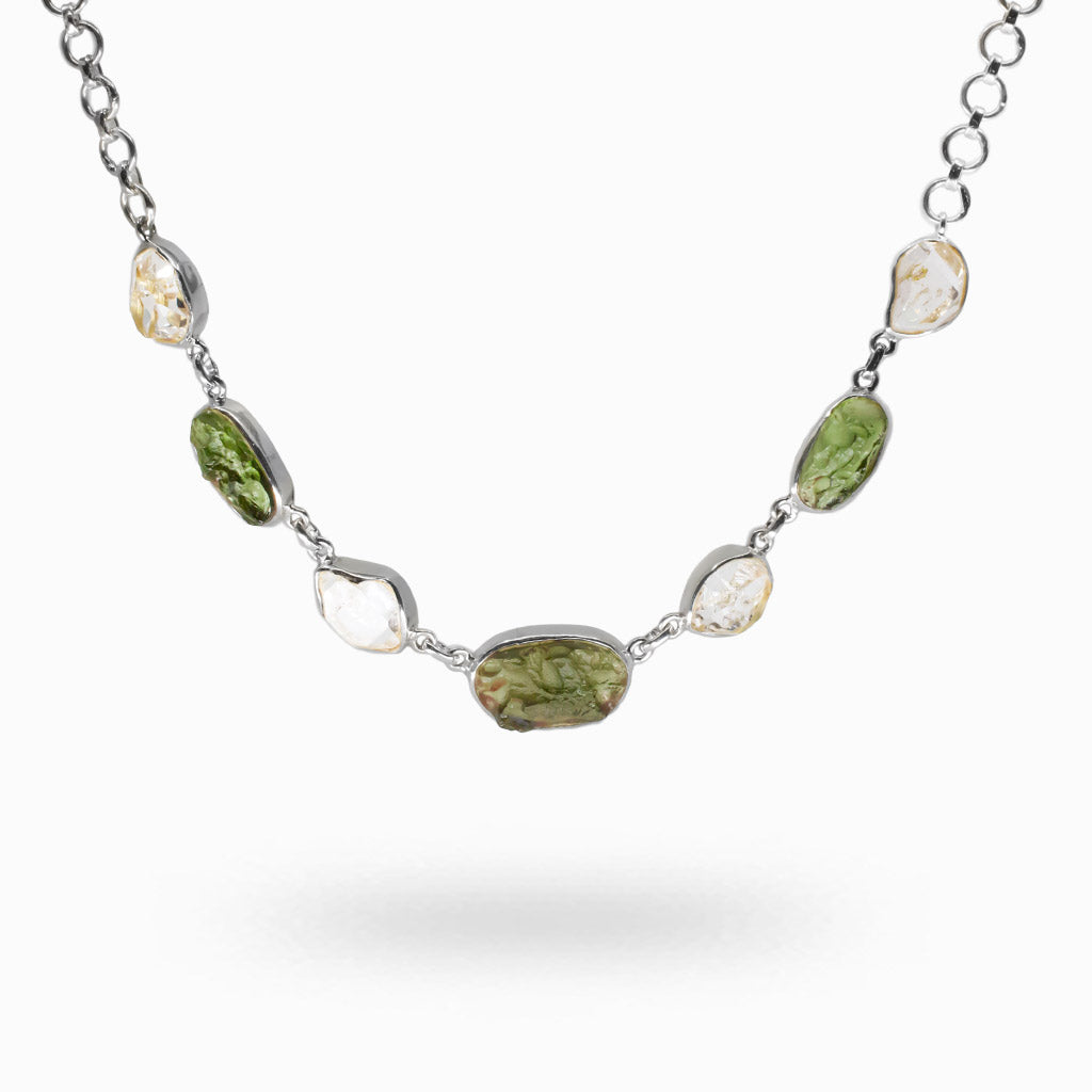 Raw green Moldavite and clear Herkimer Diamond stones set in sterling silver bezels along a silver chain multistone necklace. | MADE IN EARTH