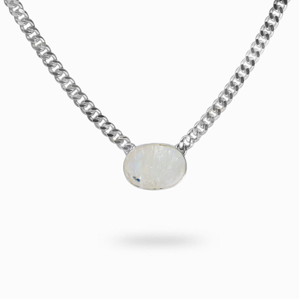 Raw oval Rainbow Moonstone bezel set in sterling silver on a silver chain with natural blue flash and iridescent tones. | MADE IN EARTH