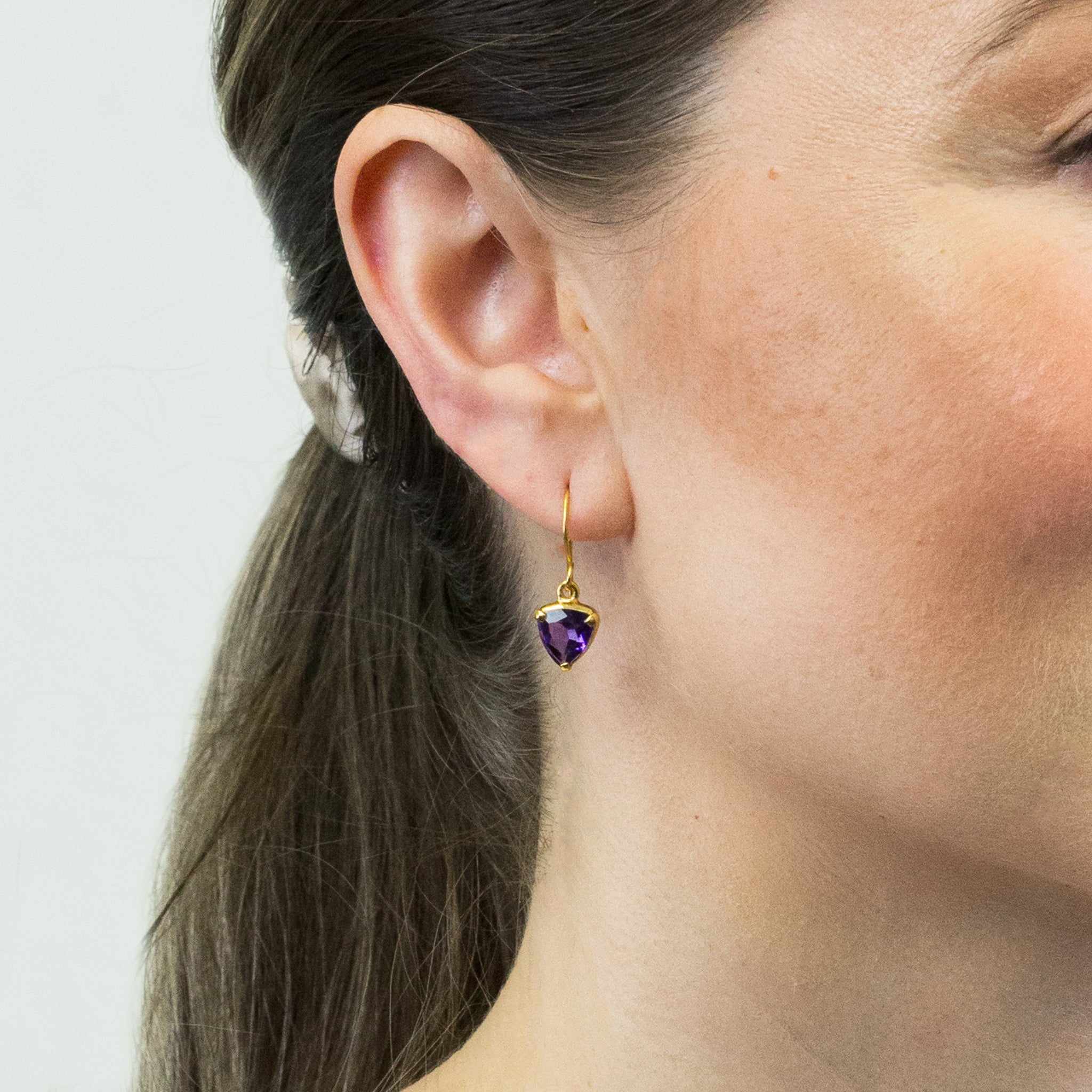 FACETED AMETHYST TRIANGLE CLAW WITH GOLD VERMEIL FINISH DROP EARRINGS ON MODEL