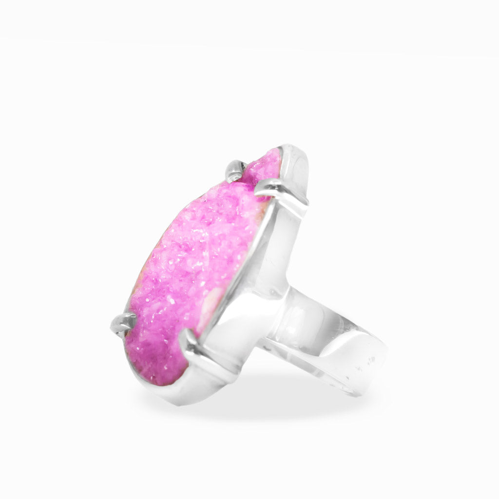 Bright pink pear-shaped Cobaltian Calcite druzy ring with sparkling crystalline texture and polished sterling silver prong setting.
