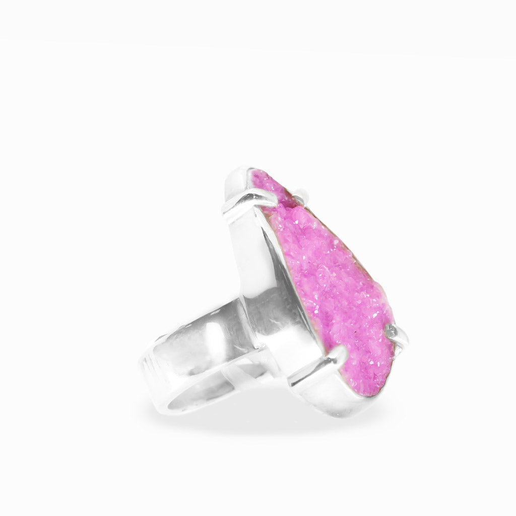 Bright pink pear-shaped Cobaltian Calcite druzy ring with sparkling crystalline texture and polished sterling silver prong setting.