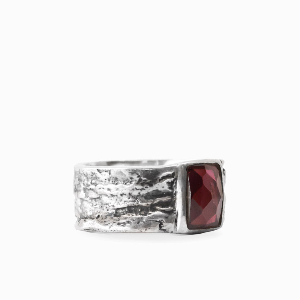 Rectangular faceted red Garnet gemstone set in a wide textured 925 sterling silver ring.