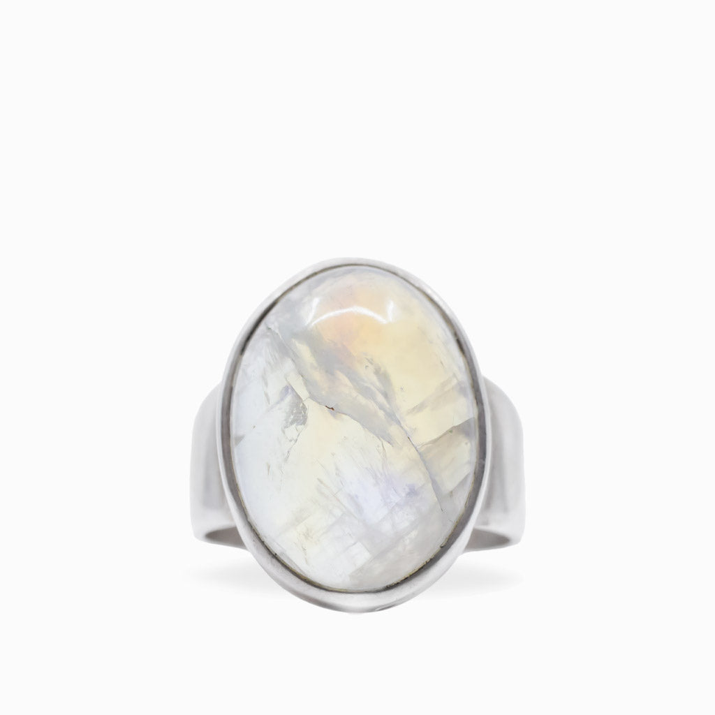 Oval Rainbow Moonstone cabochon ring with luminous white iridescence set in polished 925 sterling silver.