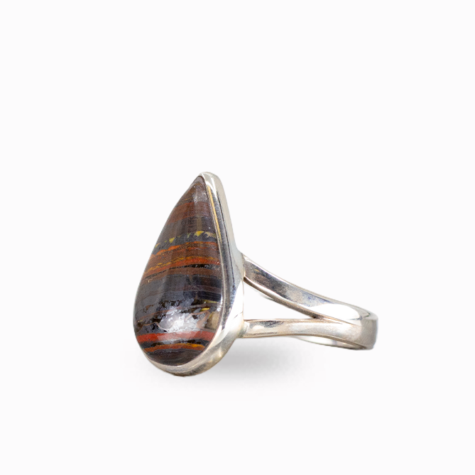 Pear-shaped Tiger Iron ring with layered rust-red, golden, and dark metallic bands, polished sterling silver bezel, and openwork band.