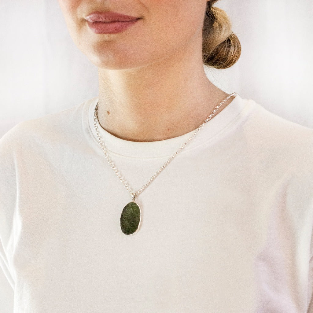 Model Wearing Light forest green Moldavite tektite necklace Oval shape