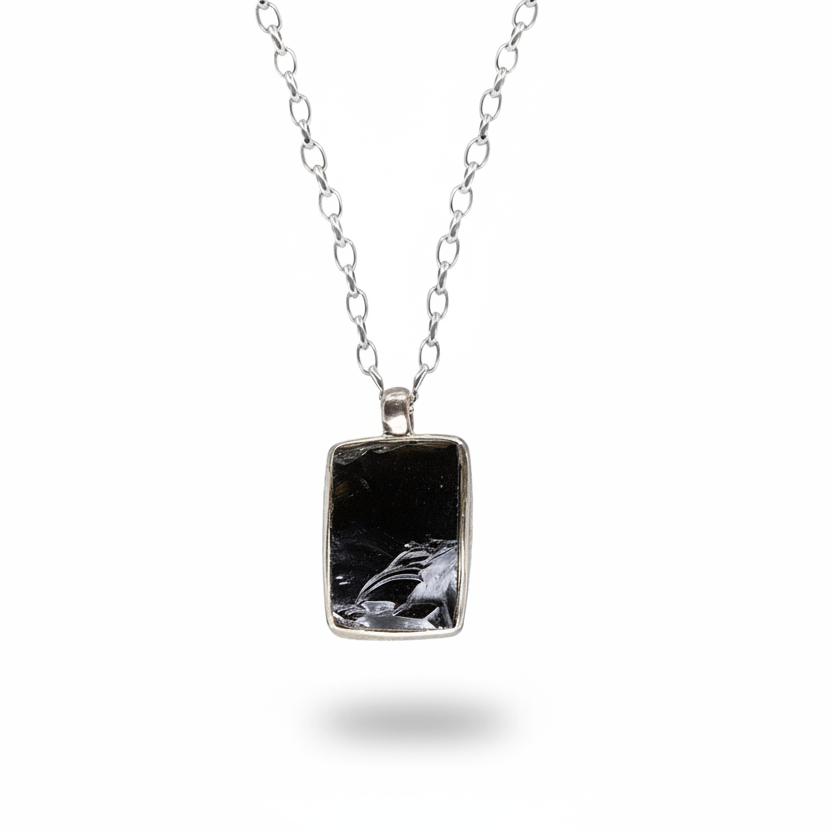 Apache tear obsidian pendant with dark polished surface in sterling silver necklace
