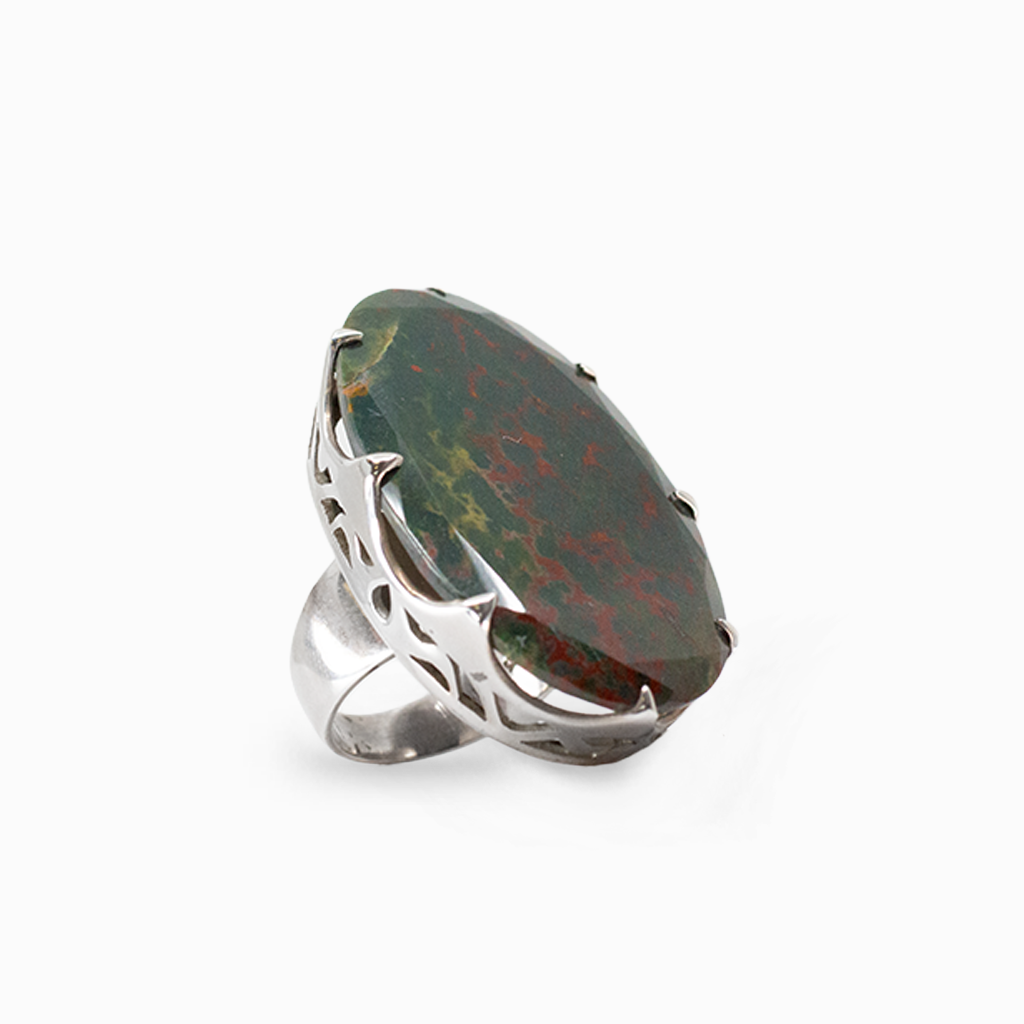 Faceted oval dark green Bloodstone with natural red markings held by sterling silver prongs.