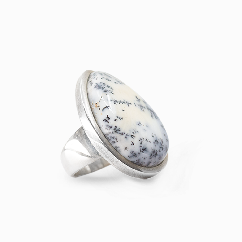 Teardrop Dendritic Opal with black branch-like inclusions framed in a smooth sterling silver setting.