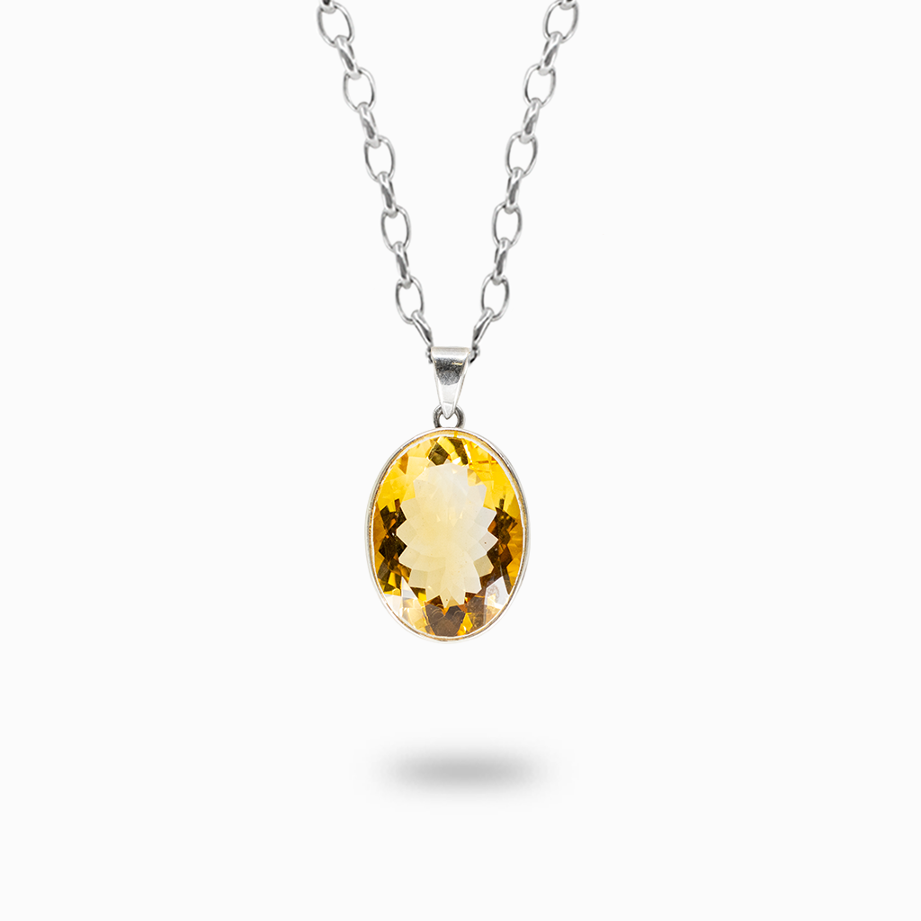 Faceted oval golden-yellow Citrine pendant necklace in a polished sterling silver bezel setting.
