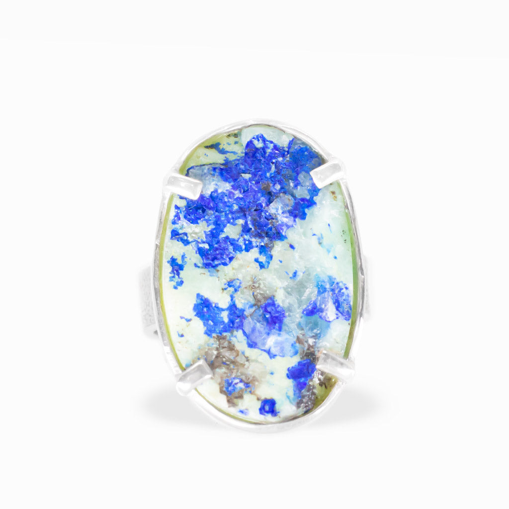 Oval Azurite Chrysocolla in Quartz ring with vivid electric-blue crystal clusters, pale green and white matrix, and sterling silver prongs.