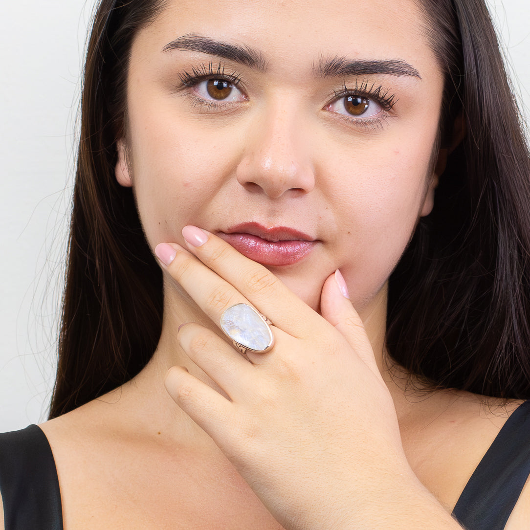 Raw rainbow moonstone ring with white stone and blue flash set in silver