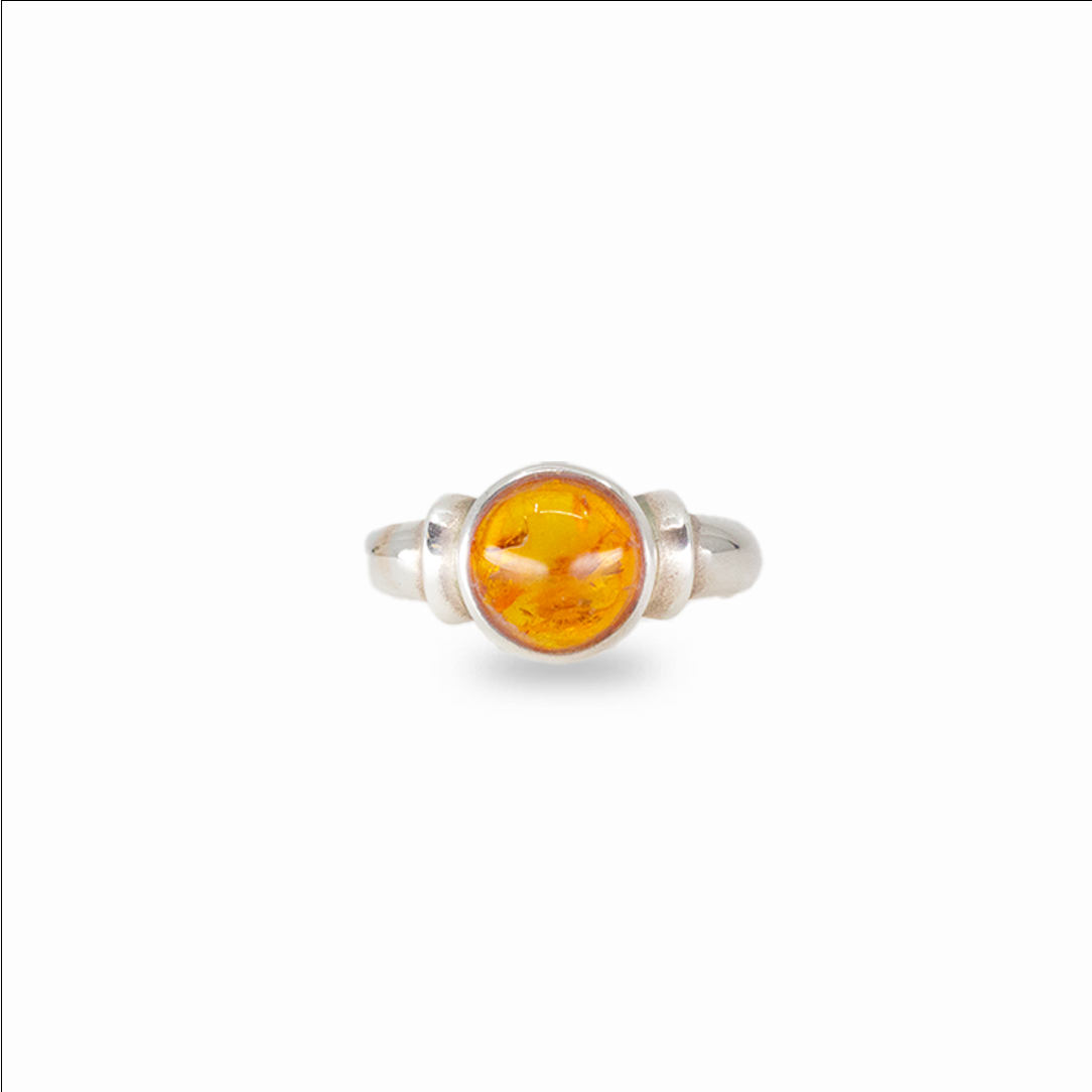 Round amber ring with warm golden fossilized resin set in sterling silver