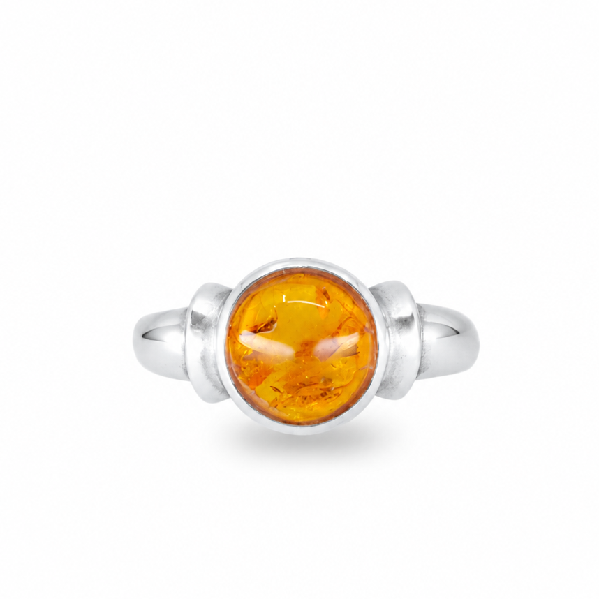 Round amber ring with warm golden fossilized resin set in sterling silver