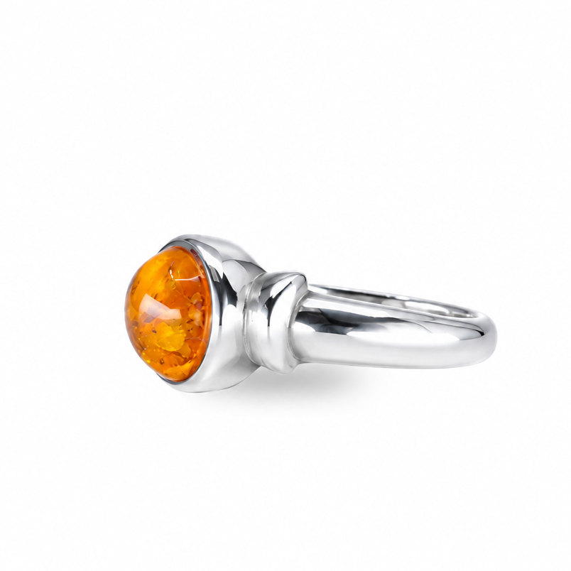 Round amber ring with warm golden fossilized resin set in sterling silver