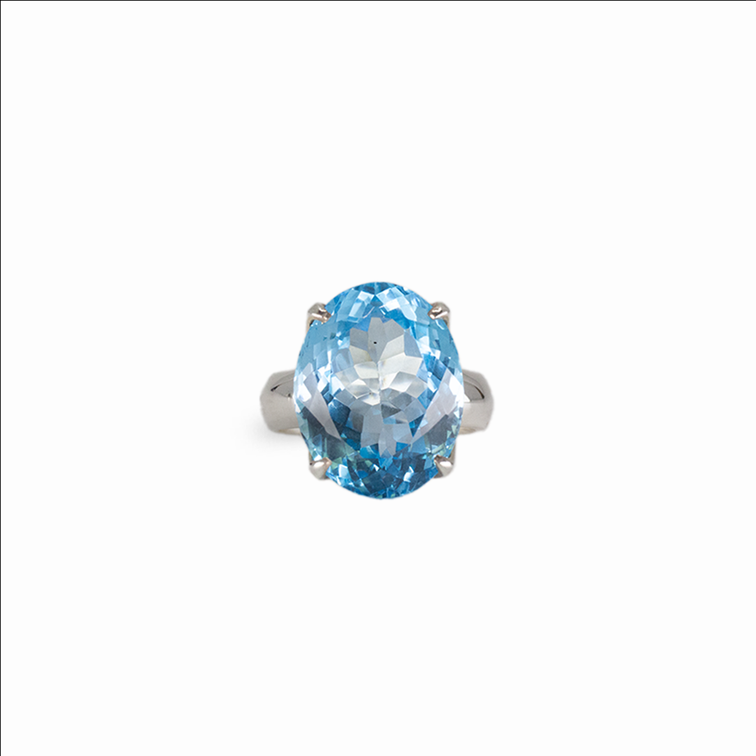 Oval blue topaz gemstone ring in sterling silver with brilliant electric blue color and prong setting