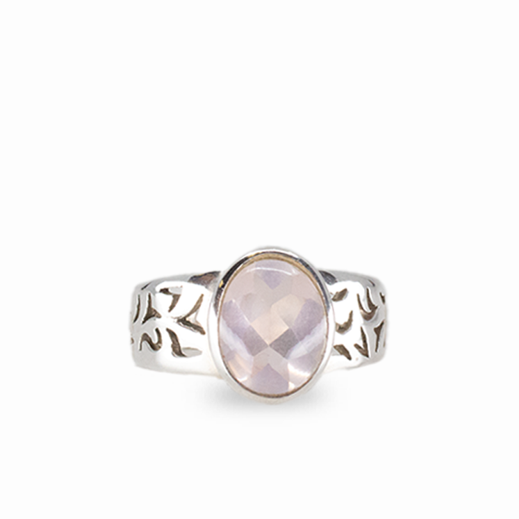 Oval rose quartz gemstone ring in sterling silver with soft pink faceted stone on white background