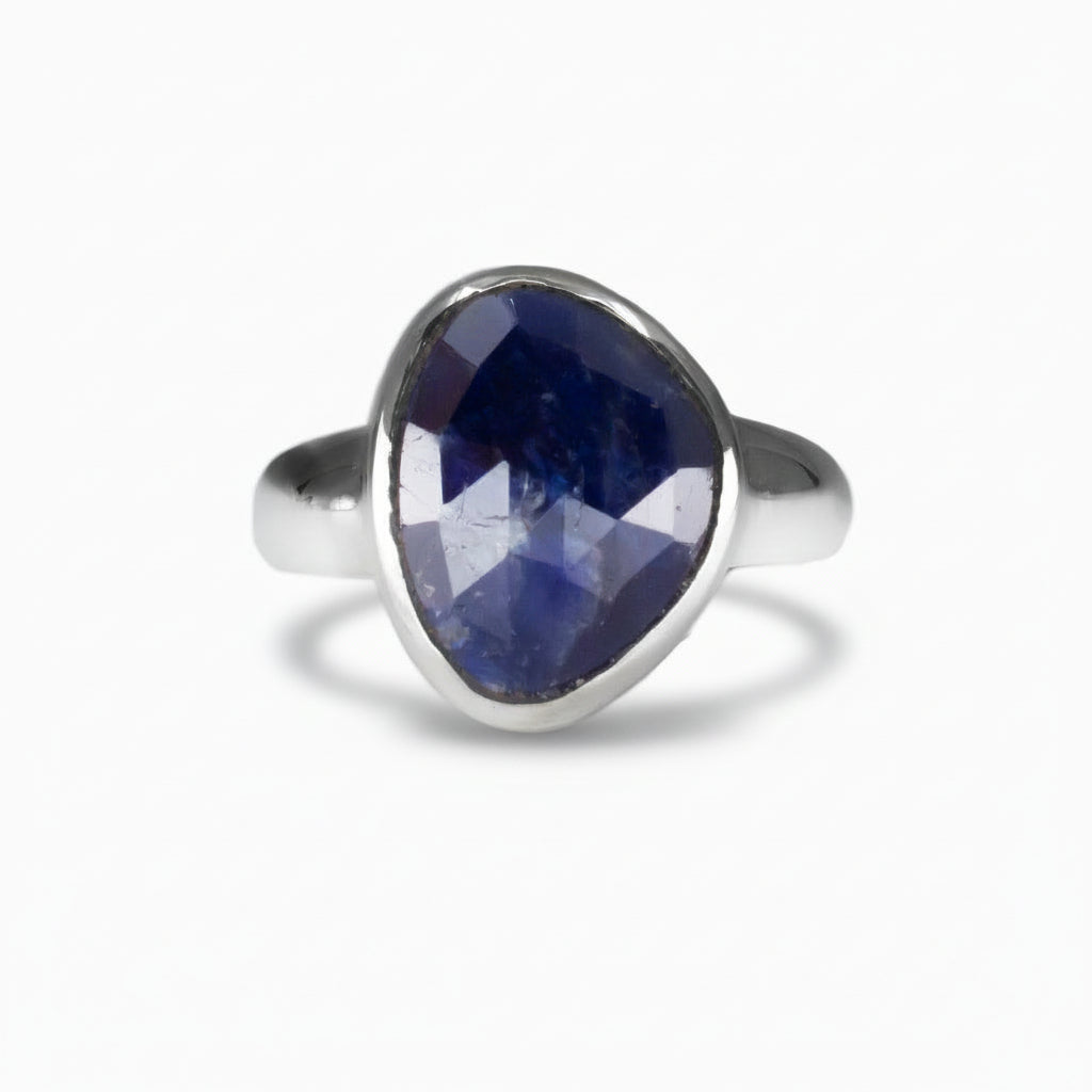 Faceted freeform deep blue Sapphire ring set in polished sterling silver, showing natural internal texture on a white background. | MADE IN EARTH 