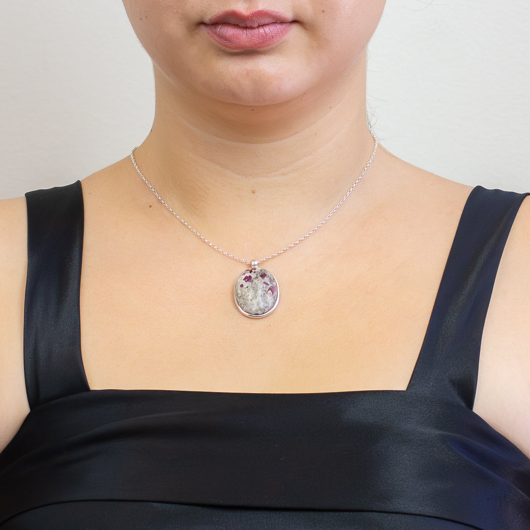 Oval Ruby in Matrix pendant featuring deep crimson ruby crystals within a pale marbled stone, set in polished sterling silver on a chain. | MADE IN EARTH