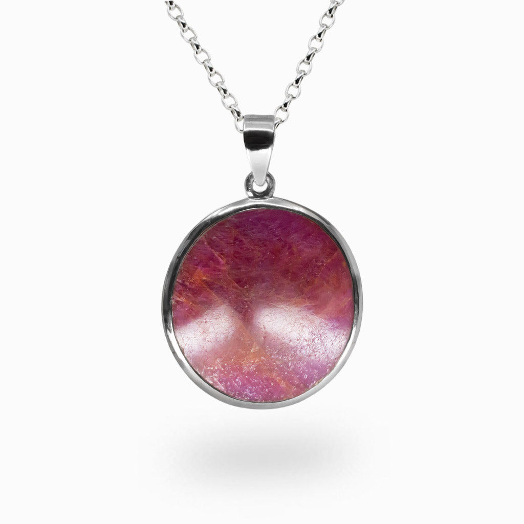 Round pink-red Ruby pendant set in sterling silver with vivid natural color variations.