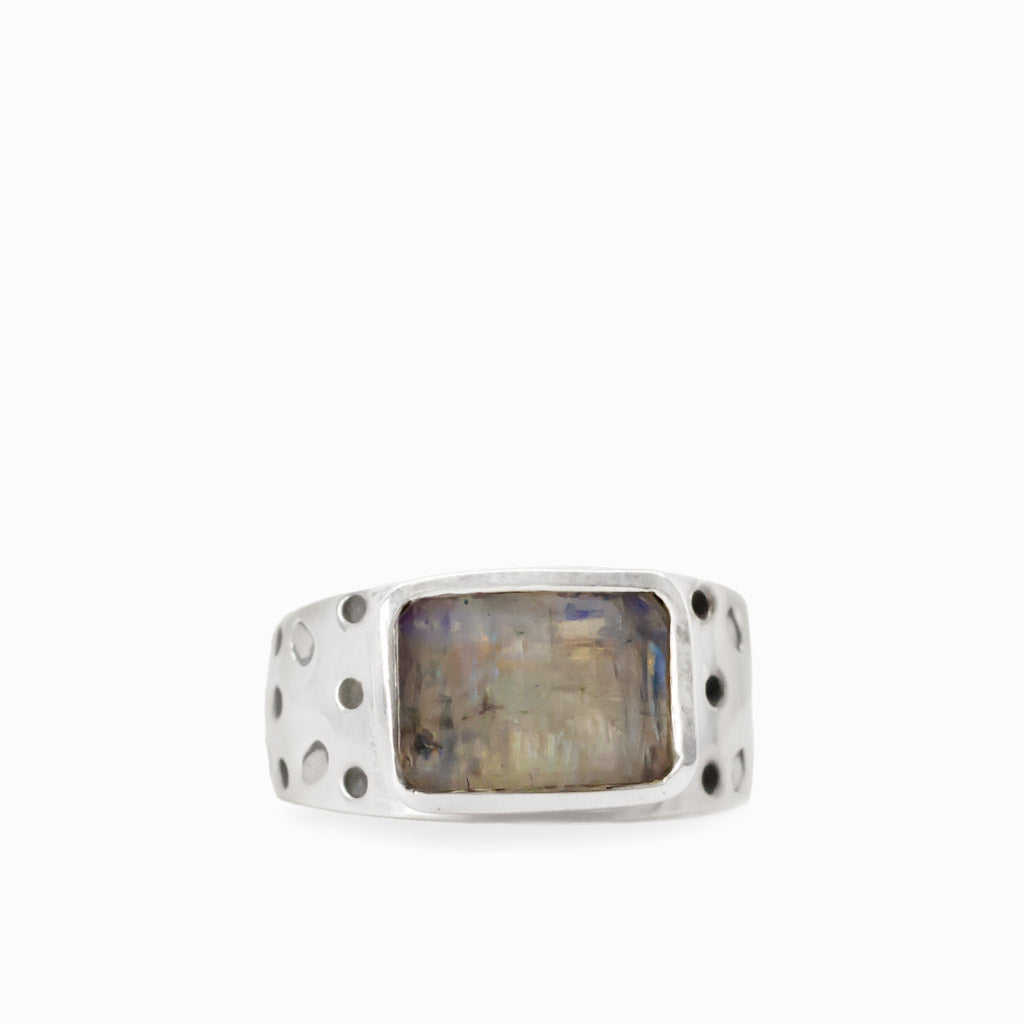 Rectangular Rainbow Moonstone cabochon with subtle iridescent flashes set in a textured 925 sterling silver ring.