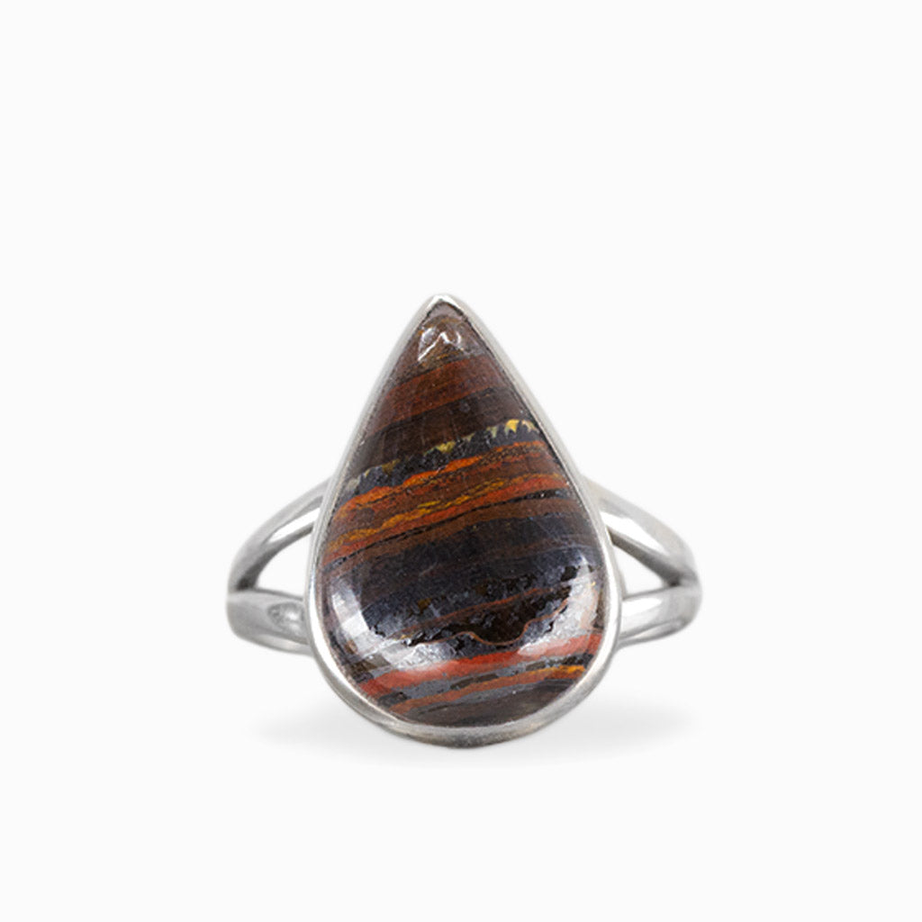 Pear-shaped Tiger Iron ring with layered rust-red, golden, and dark metallic bands, polished sterling silver bezel, and openwork band.