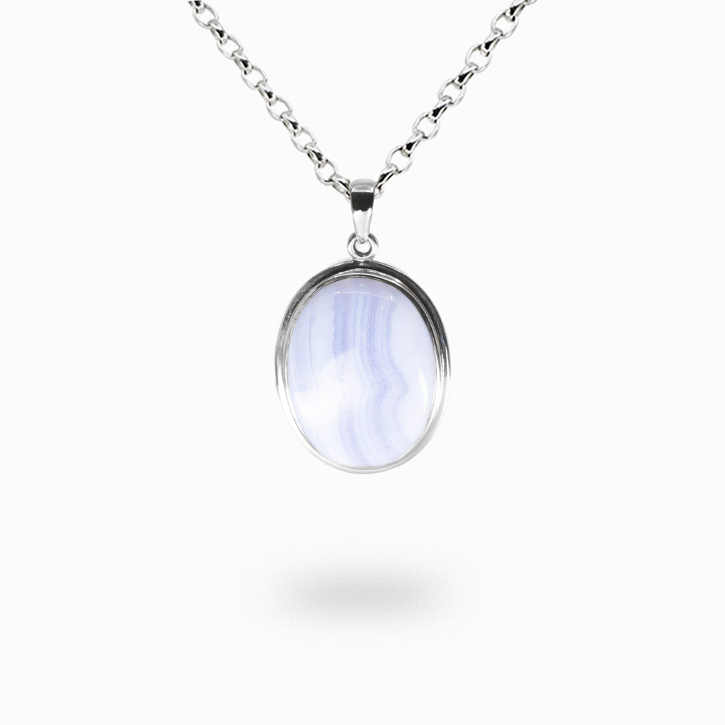 Oval Blue Lace Agate pendant necklace with pale sky-blue and white banded stone, polished finish, set in sterling silver on a silver chain. | MADE IN EARTH