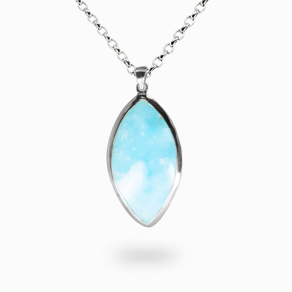 Marquise-shaped hemimorphite pendant with pale blue and white cloud-like patterns set in a sterling silver bezel on a silver chain. | MADE IN EARTH
