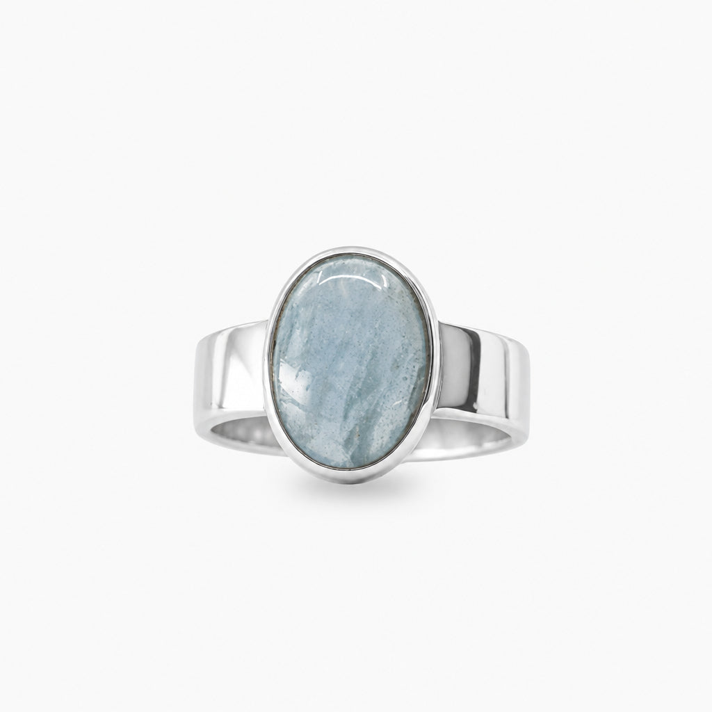 Pale blue oval Aquamarine cabochon ring in polished 925 sterling silver with a smooth bezel setting and wide polished band.