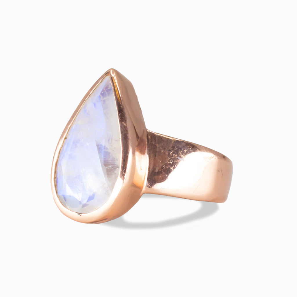 Pear-shaped Rainbow Moonstone ring in rose gold vermeil with blue iridescent sheen on white background |MADE IN EARTH