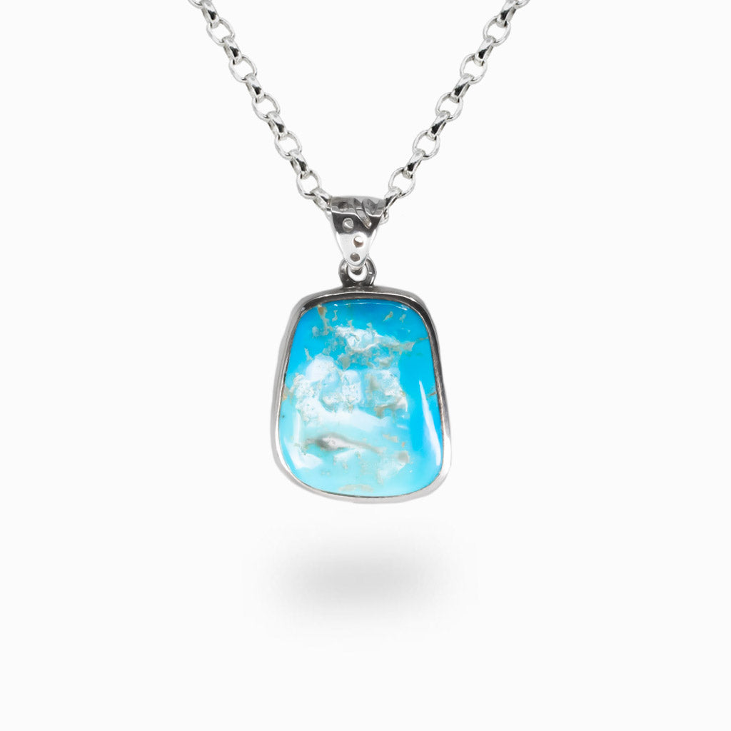 Raw Sleeping Beauty Turquoise necklace in sterling silver bezel with vibrant sky-blue natural stone pendant. | MADE IN EARTH