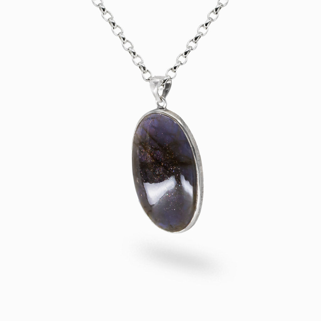Oval iolite cabochon pendant in sterling silver setting on chain. MADE IN EARTH