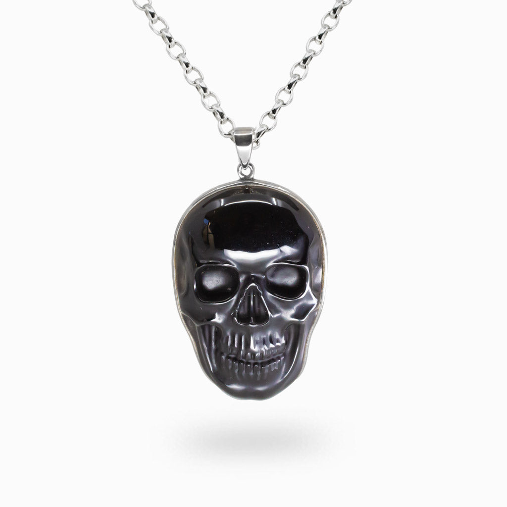 Black obsidian skull pendant in sterling silver on chain. MADE IN EARTH
