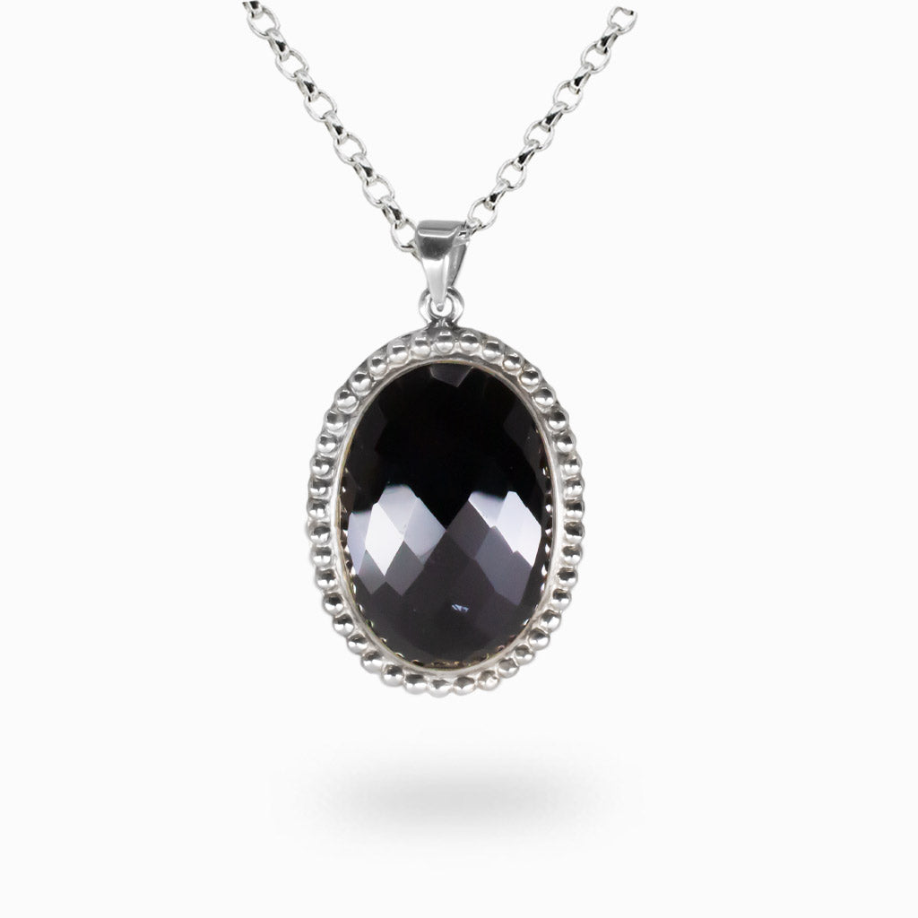 Faceted oval black onyx pendant set in sterling silver on chain