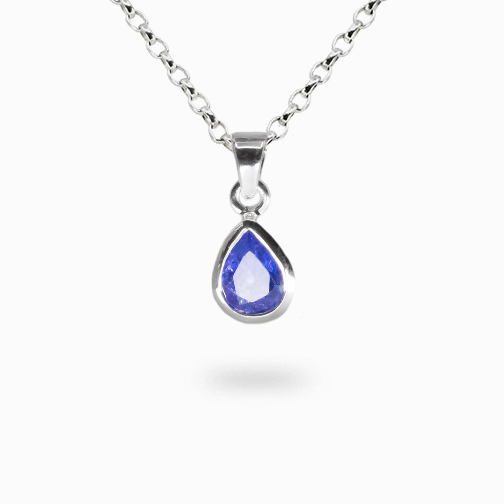 Faceted tear-shaped tanzanite gemstone pendant set in sterling silver bezel.