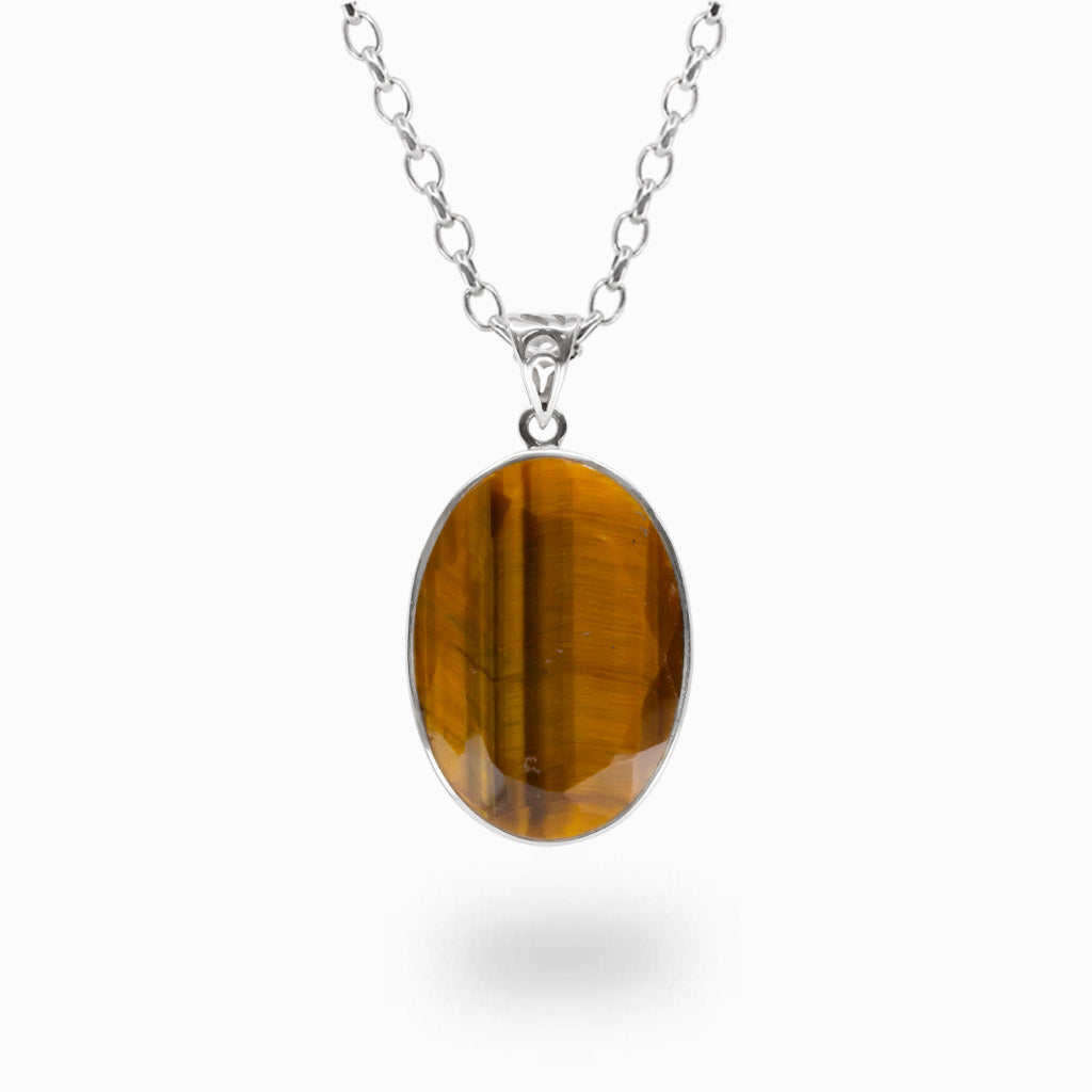 Faceted oval Tiger Eye pendant necklace in sterling silver featuring golden brown bands with natural chatoyancy.