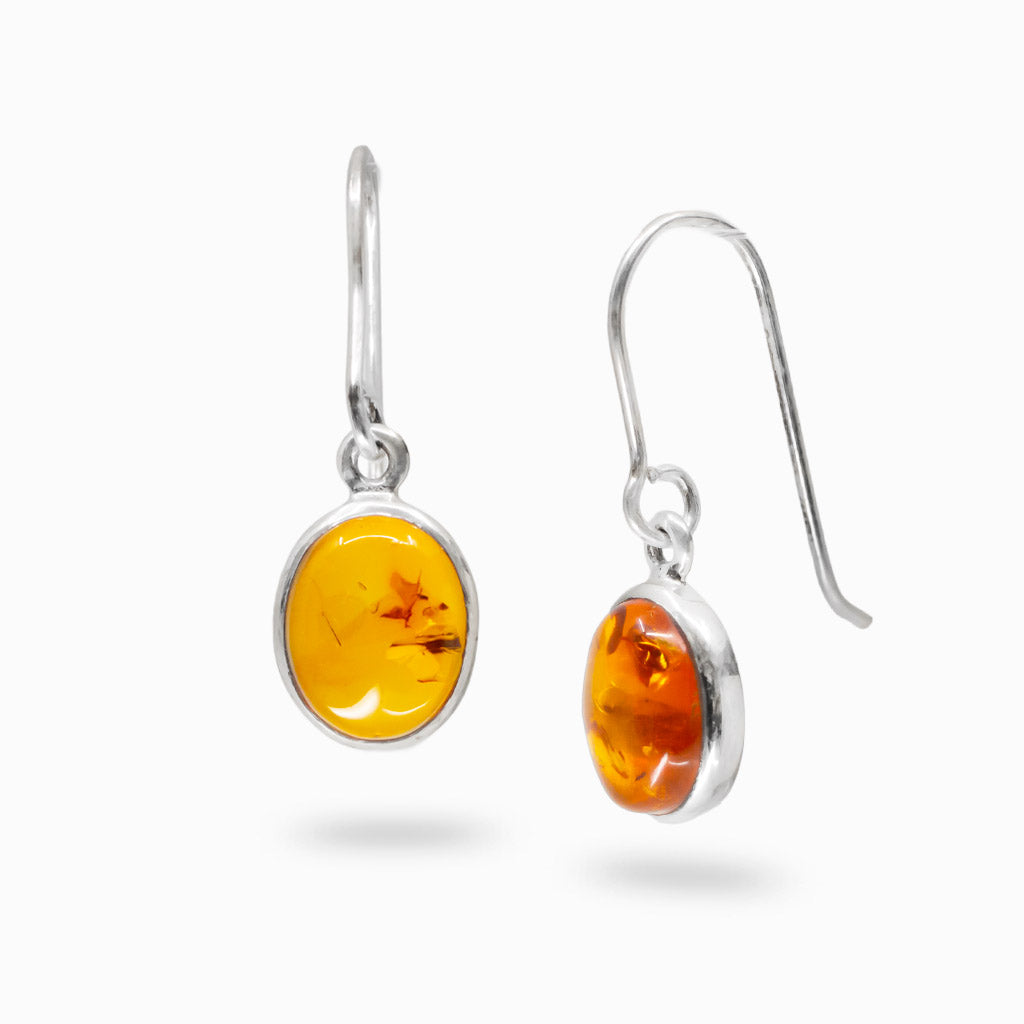 Amber oval cabochon bezel drop earrings in sterling silver with warm golden tones