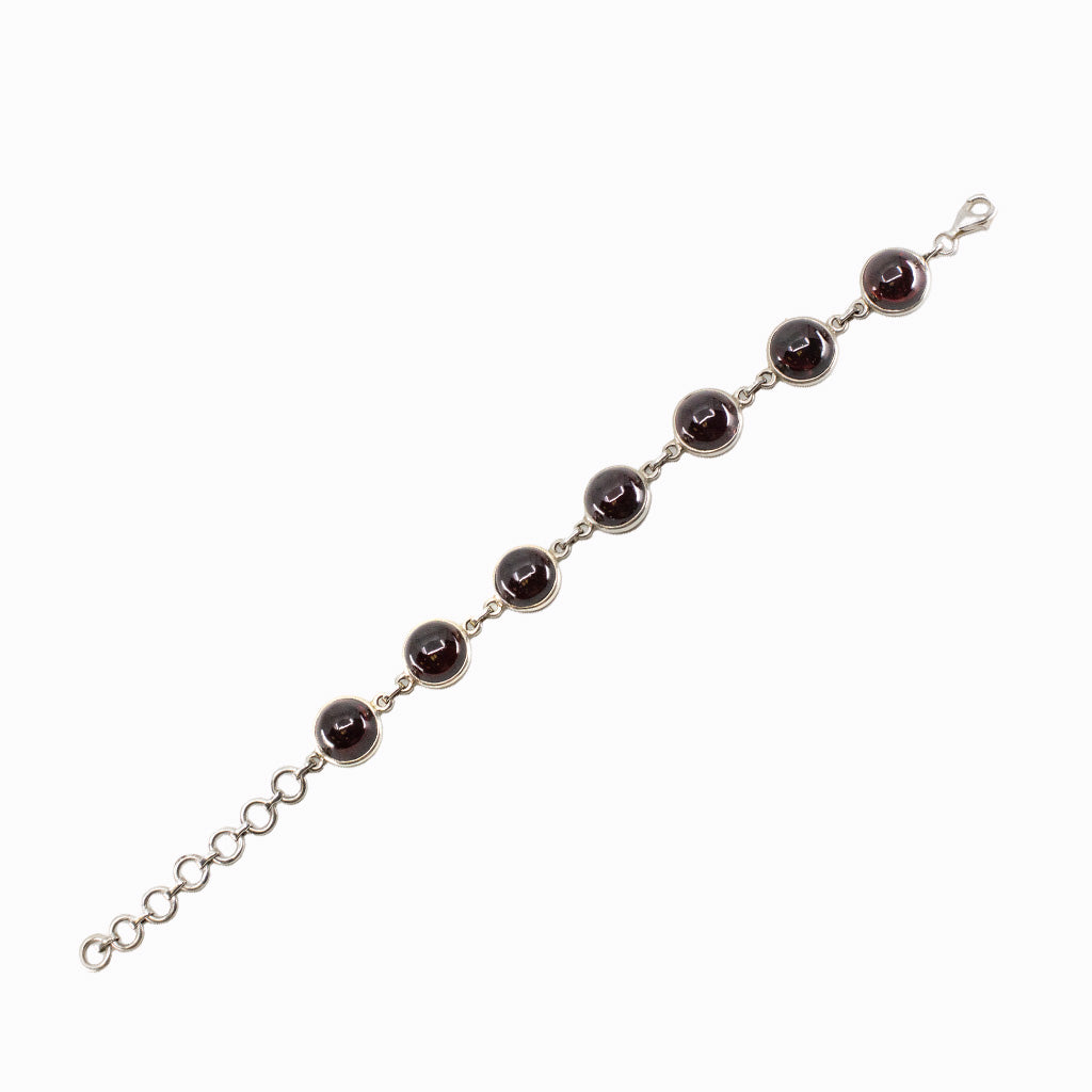Sterling silver Garnet bracelet featuring faceted deep red gemstones with elegant sparkle and timeless design.