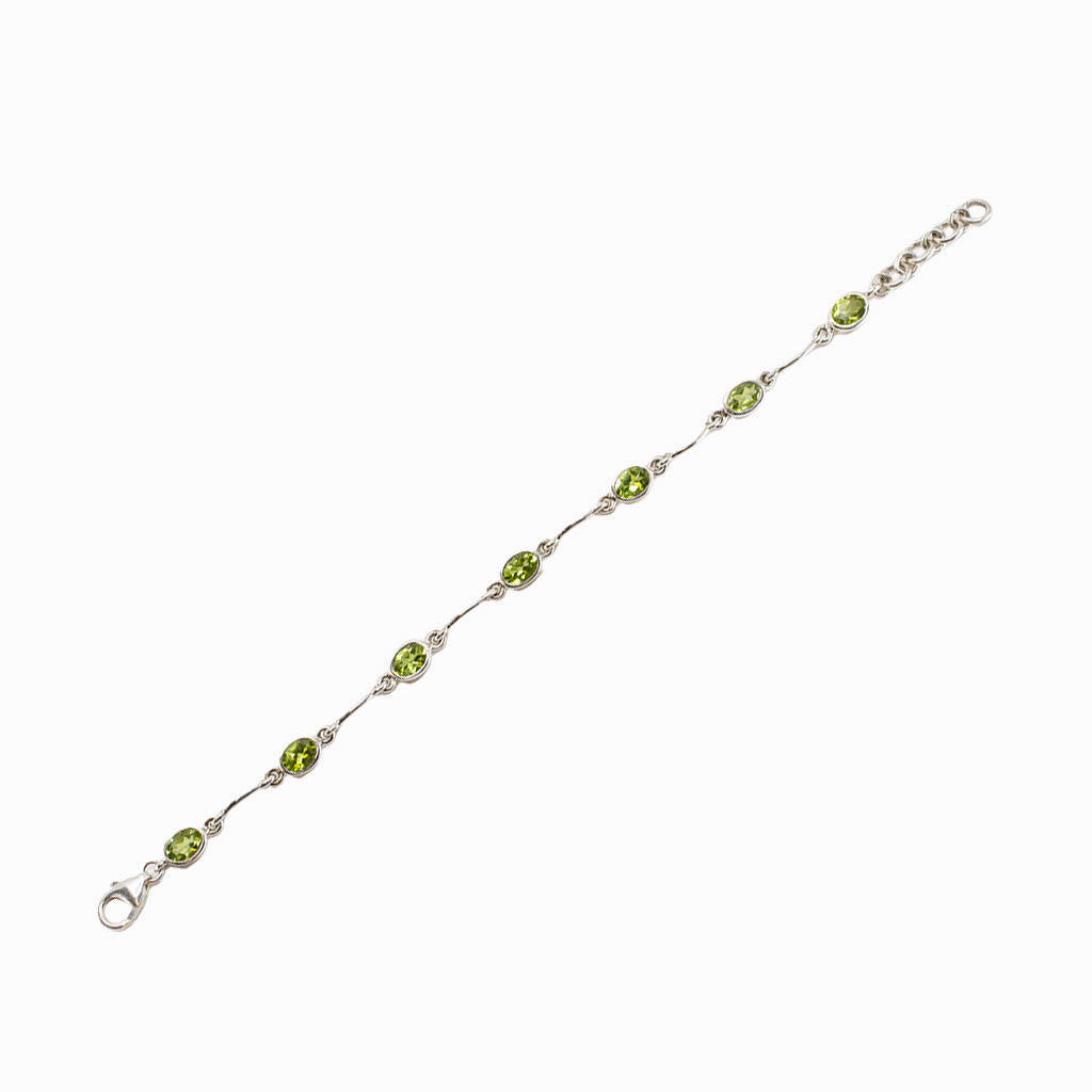 Faceted Peridot bracelet in sterling silver with oval green gemstones.