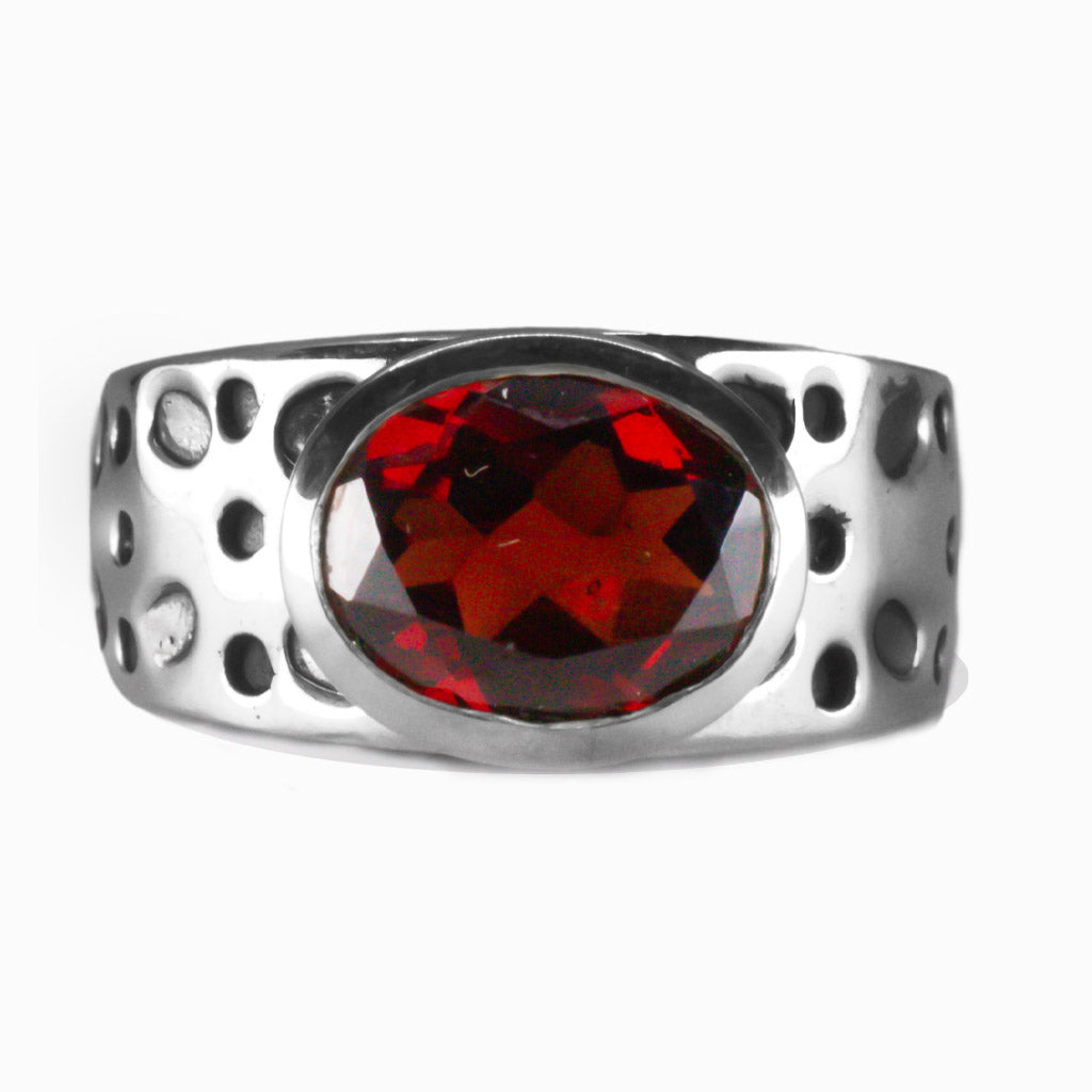 Faceted oval Garnet ring with textured sterling silver band, deep red gemstone with rich shine. | MADE IN EARTH