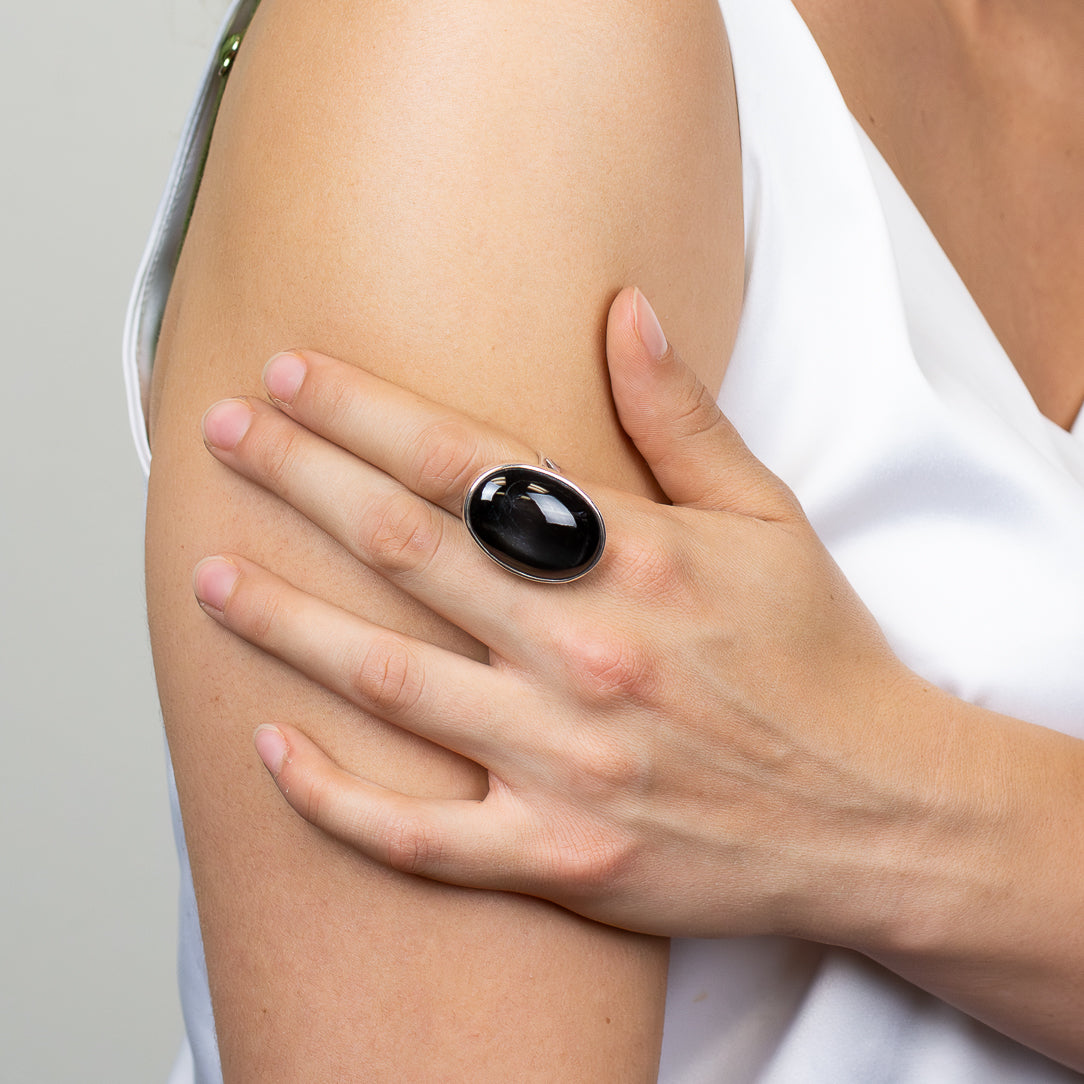 Oval Black Star Diopside ring with glossy black cabochon gemstone and polished 925 sterling silver bezel setting.