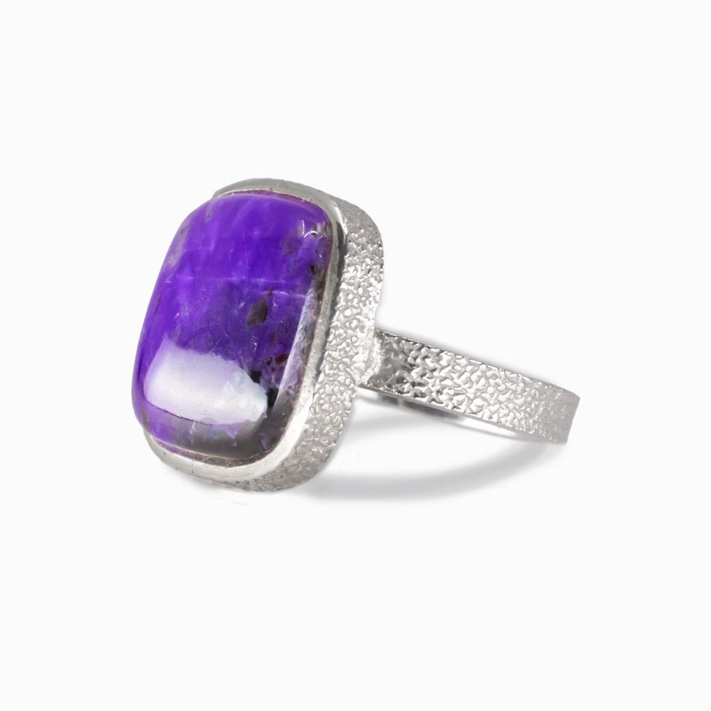 Square purple Sugilite cabochon ring set in sterling silver bezel with textured band. MADE IN EARTH